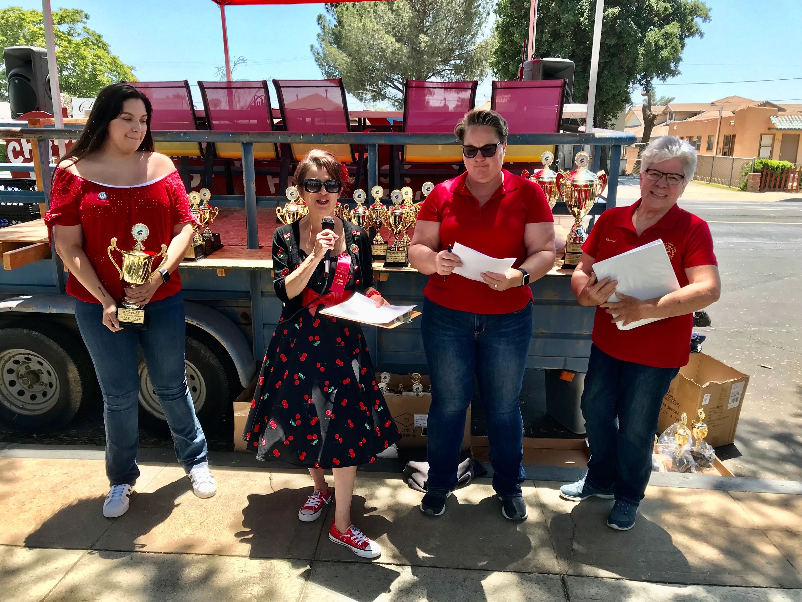 Cherry Festival parade contest winners holding trophies and ribbons