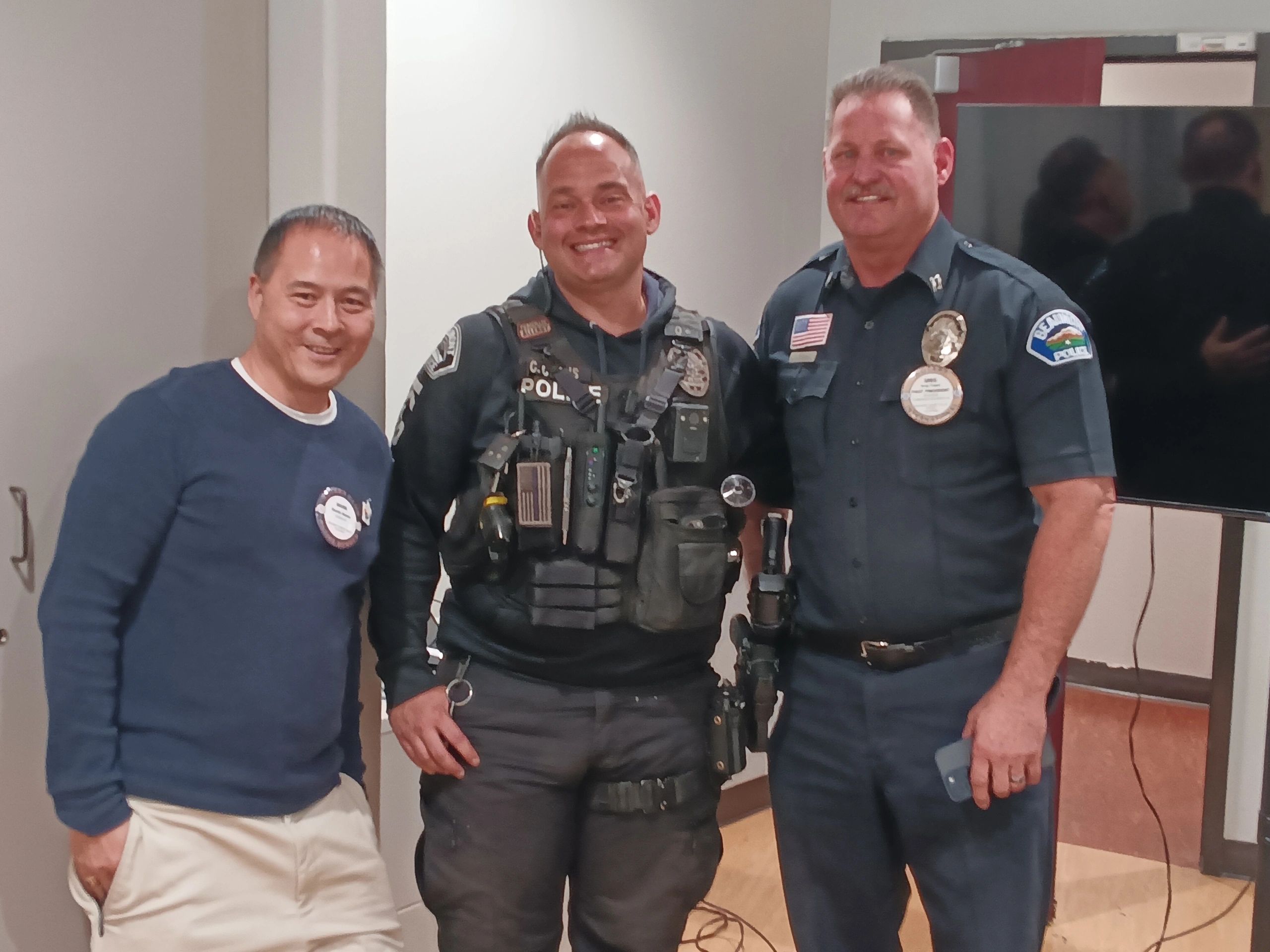 A Beaumont police officer and firefighter standing with a Rotarian