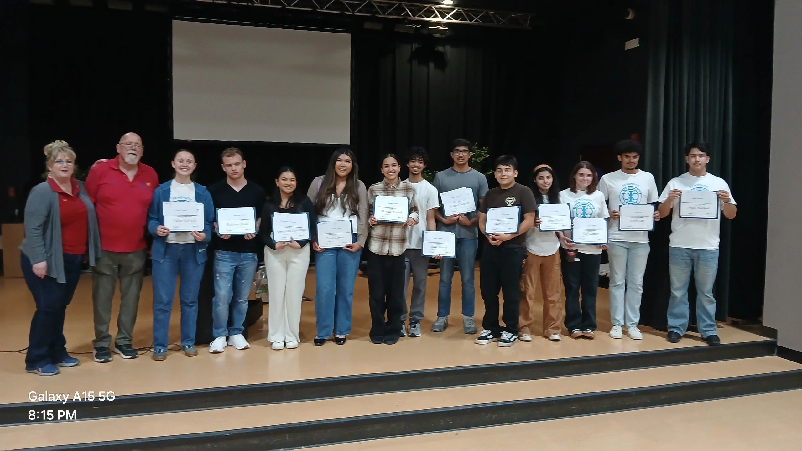 Group of Beaumont scholarship recipients on stage holding certificates