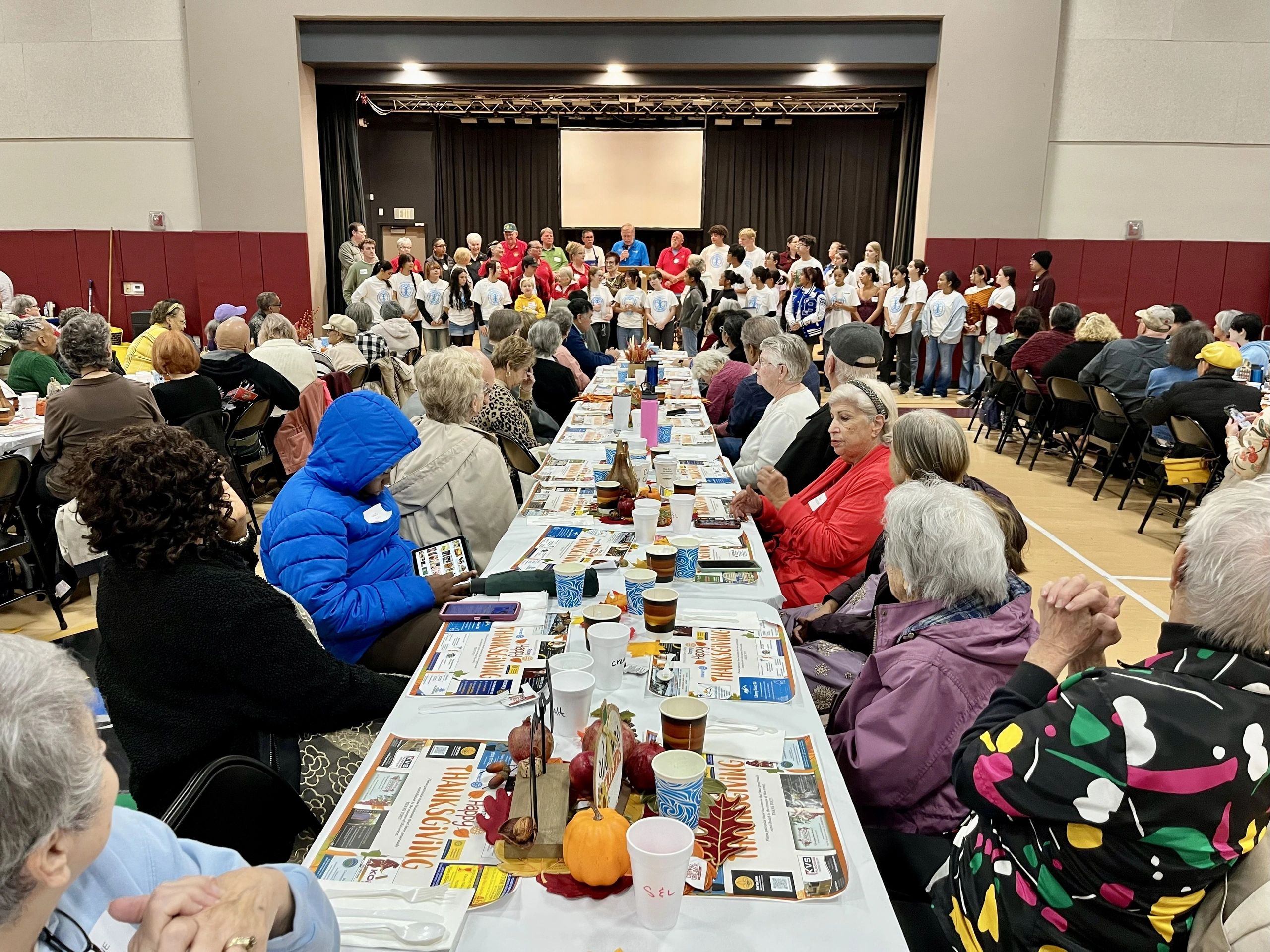 Seniors sharing a meal at a long banquet table