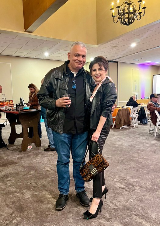 A guest couple in coordinating leather and leopard print