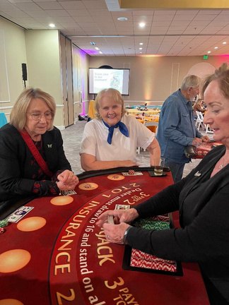Three guests at a blackjack table