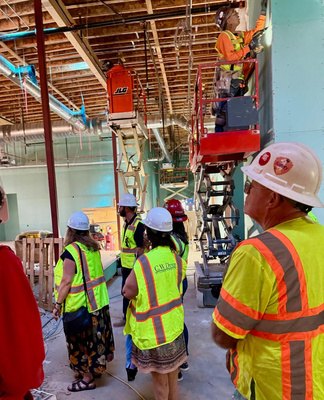 Construction crew working on overhead structure during the tour