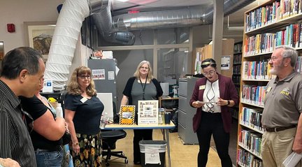 Library staff explaining ongoing programs during the tour