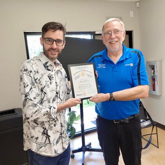 Steven Brown receiving his new-member certificate from President Doug Emery